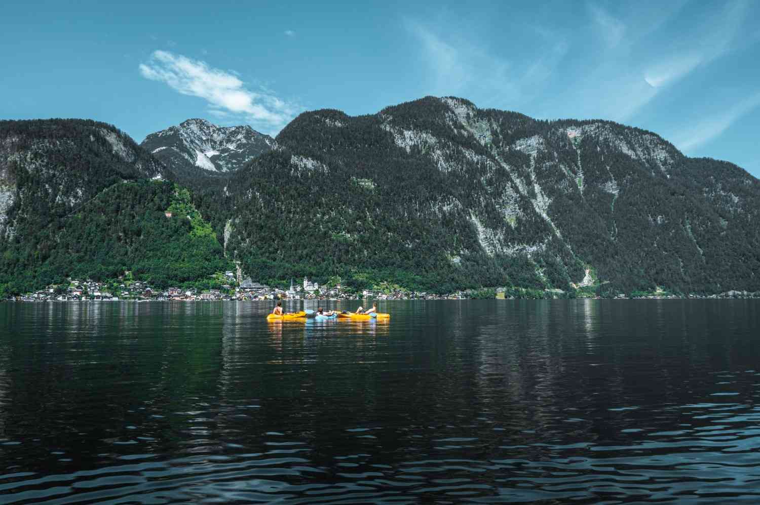 inflatable kayaks paddling on calm mountain lake