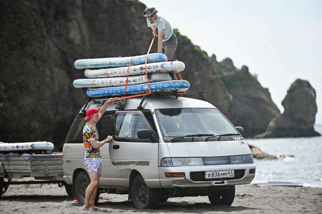 kayak straps and tie down lines secured on car roof rack