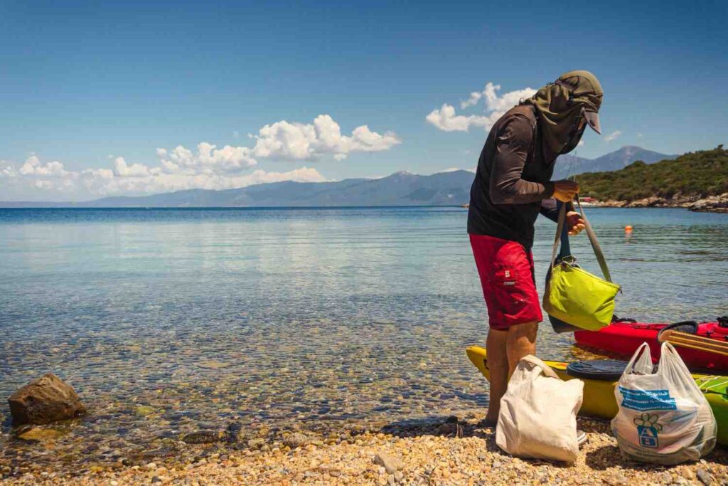 kayak dry bag packing on beach before trip