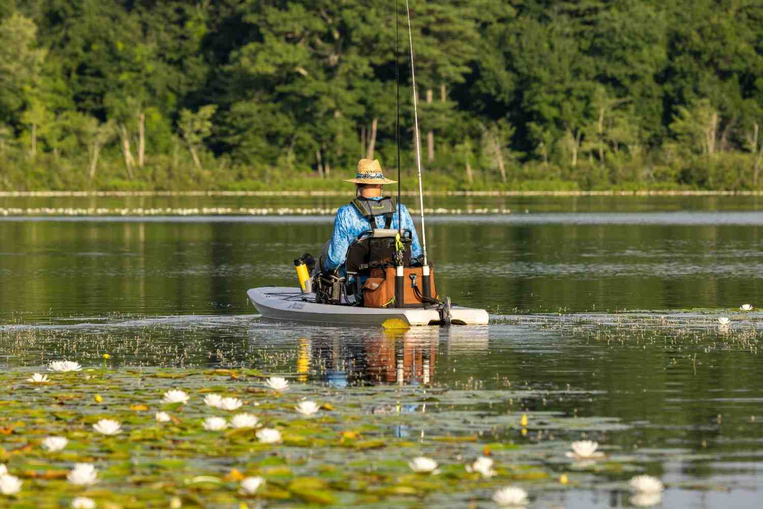 fishing kayak with trolling motor setup on calm lake