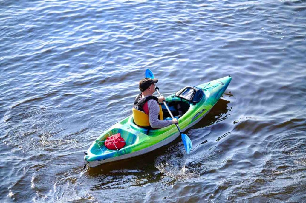 kayak setup with dry bag and life jacket on water