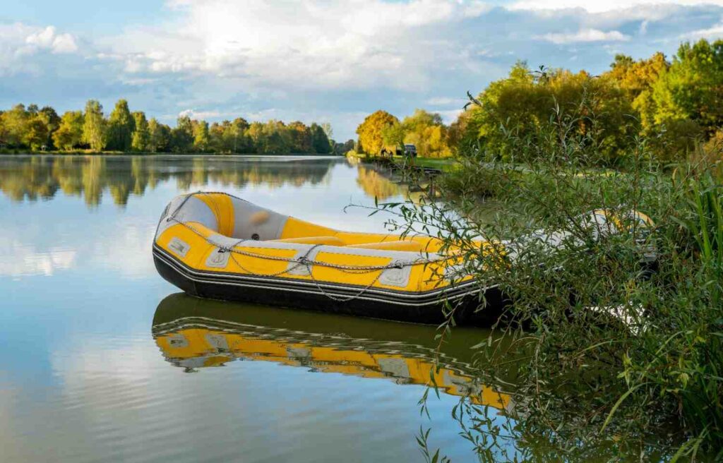 yellow inflatable kayak on calm lake recreational type