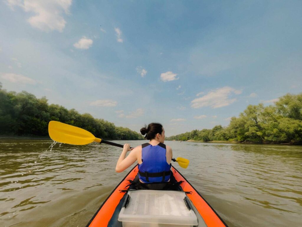 kayak paddling with life jacket and paddle on calm river